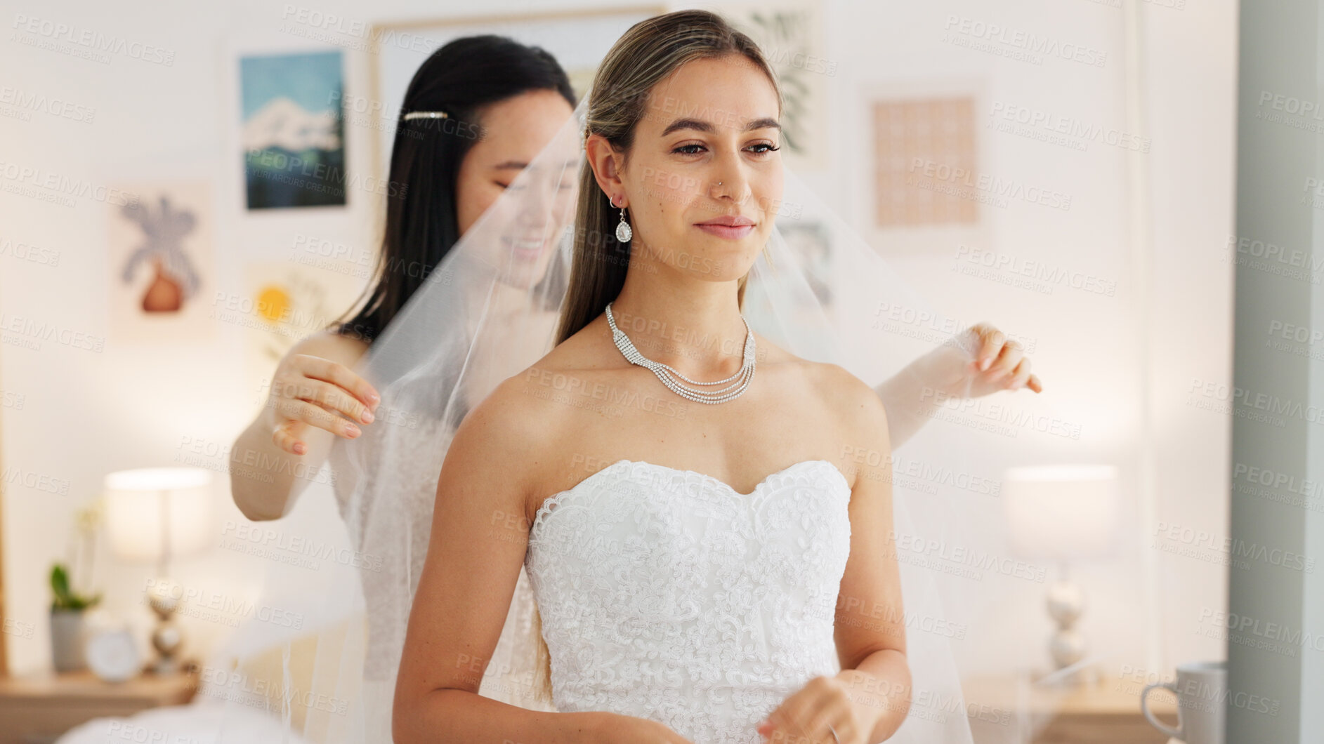 Buy stock photo Wedding day, bride and maid of honor woman or friends getting dressed for event and marriage. Bridesmaid helping person with a veil and dress while happy together in room before ceremony celebration