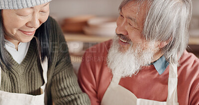 Pottery, creative and senior couple talking about art with hug and kiss together in a studio class. Elderly Asian man and woman hugging with love while learning and working with clay on a date