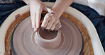 Pottery, art and hands on a potter wheel with artist spinning clay in creative class, workshop or studio. Creativity, handicraft and closeup of a sculptor working on ceramic design, craft or creation