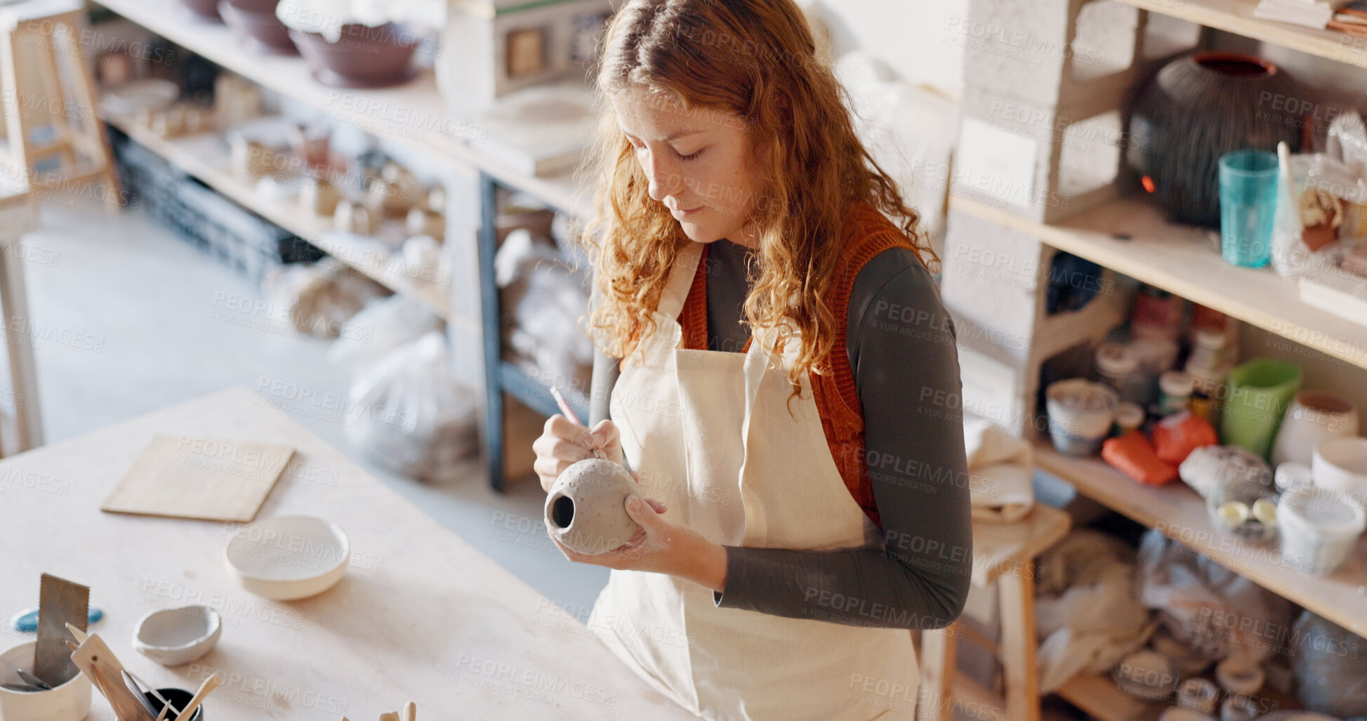 Buy stock photo Pottery, art and woman artist painting clay products in a workshop for creative small business. Industry, mud design and young female sculptor manufacturing ceramic handicraft goods in a studio.