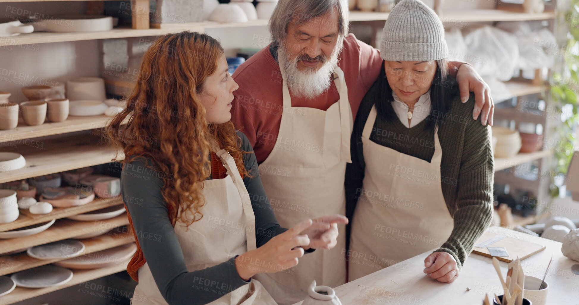 Buy stock photo Pottery, teacher and elderly couple in workshop for learning, hobby and skill together. Creative studio, art instructor and people with woman for lesson to mold clay to craft ceramic mug, cup or bowl