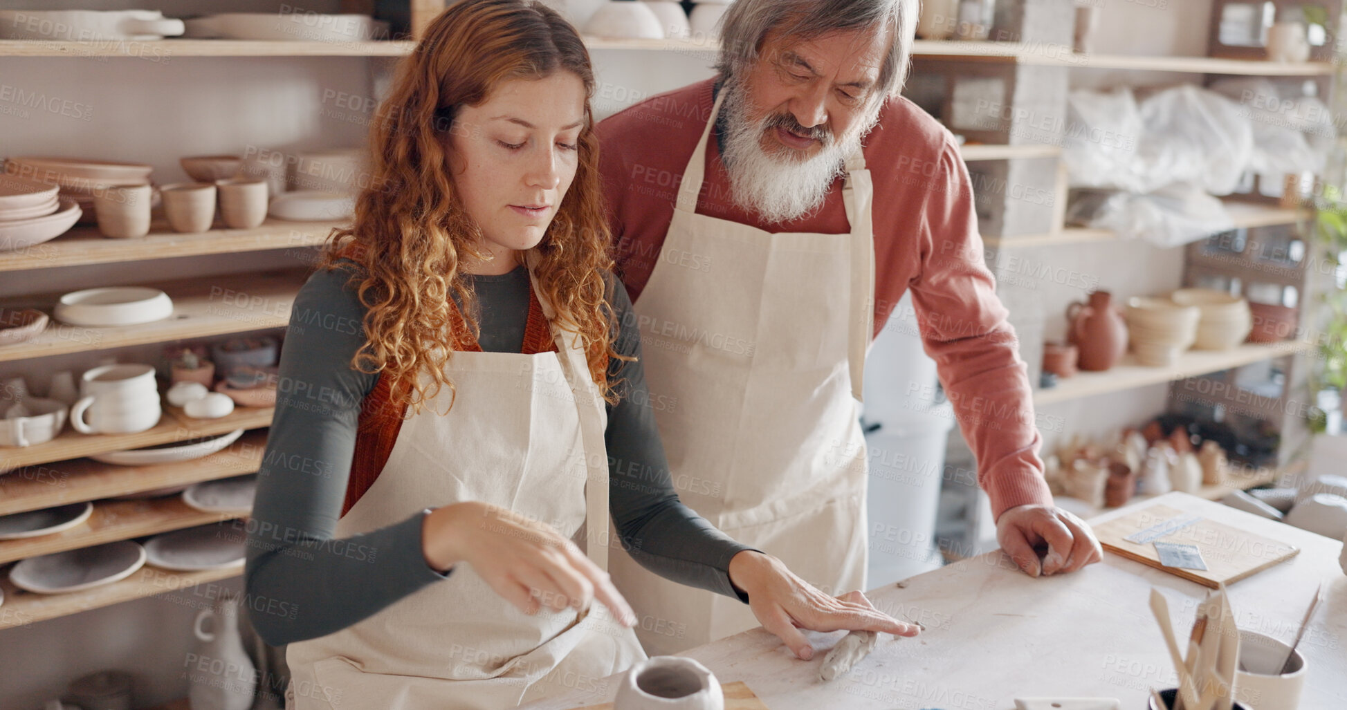 Buy stock photo Art teacher, pottery and student in a class, learning and training in creative workshop studio. Mentor, woman and man teaching to mold clay, design and craft sculpture for manufacturing in business
