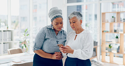 Teamwork, discussion and business women with phone looking at report, project and business proposal online. Technology, communication and senior worker talking with smartphone to explain to coworker