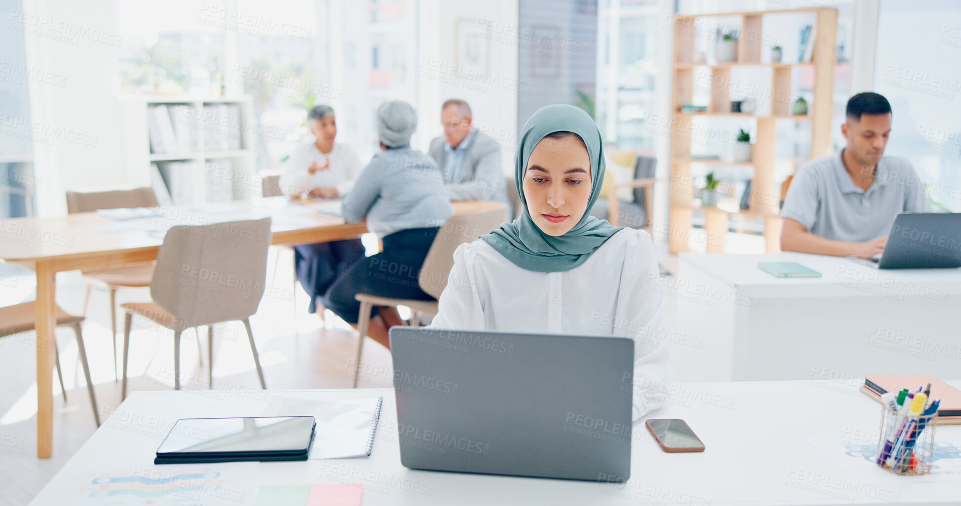 Buy stock photo Creative muslim woman, laptop and typing in office at startup company. Islamic professional, computer and designer at desk, serious or focus on business project, reading email and working on internet
