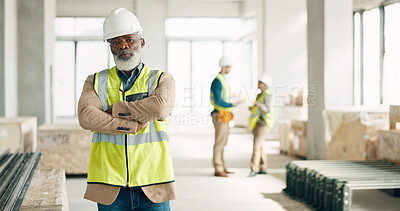 Construction, leadership and engineer with a black man architect standing on a building site with his arms crossed. Architecture, design and manager with a mature male supervisor and his team