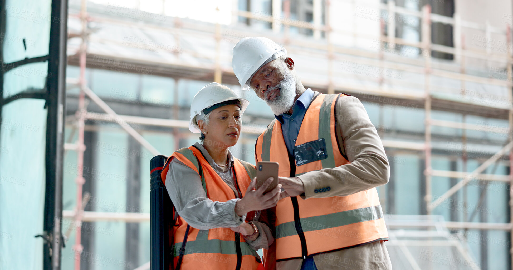 Buy stock photo Construction, teamwork and talking with phone at building, architecture site and maintenance app. Man, woman and civil engineering collaboration on mobile tech, industrial project or urban inspection