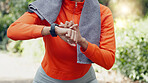 Woman sports runner with smartwatch for exercise, tracking running time and heart beat after training workout for fitness. Healthy fit girl athlete with watch for timer to track performance progress