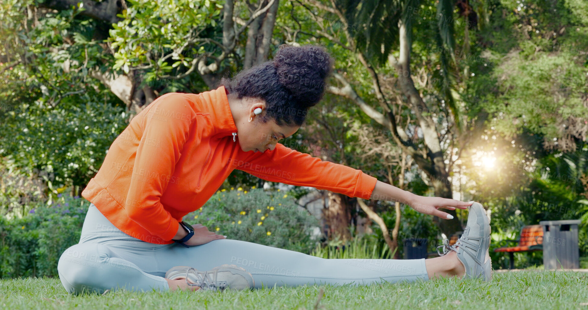 Black woman stretching leg in the park for fitness, health and wellness  before a run. Exercise, sports and female athlete warm up training outside  or in nature for mobility, flexibility and strength.