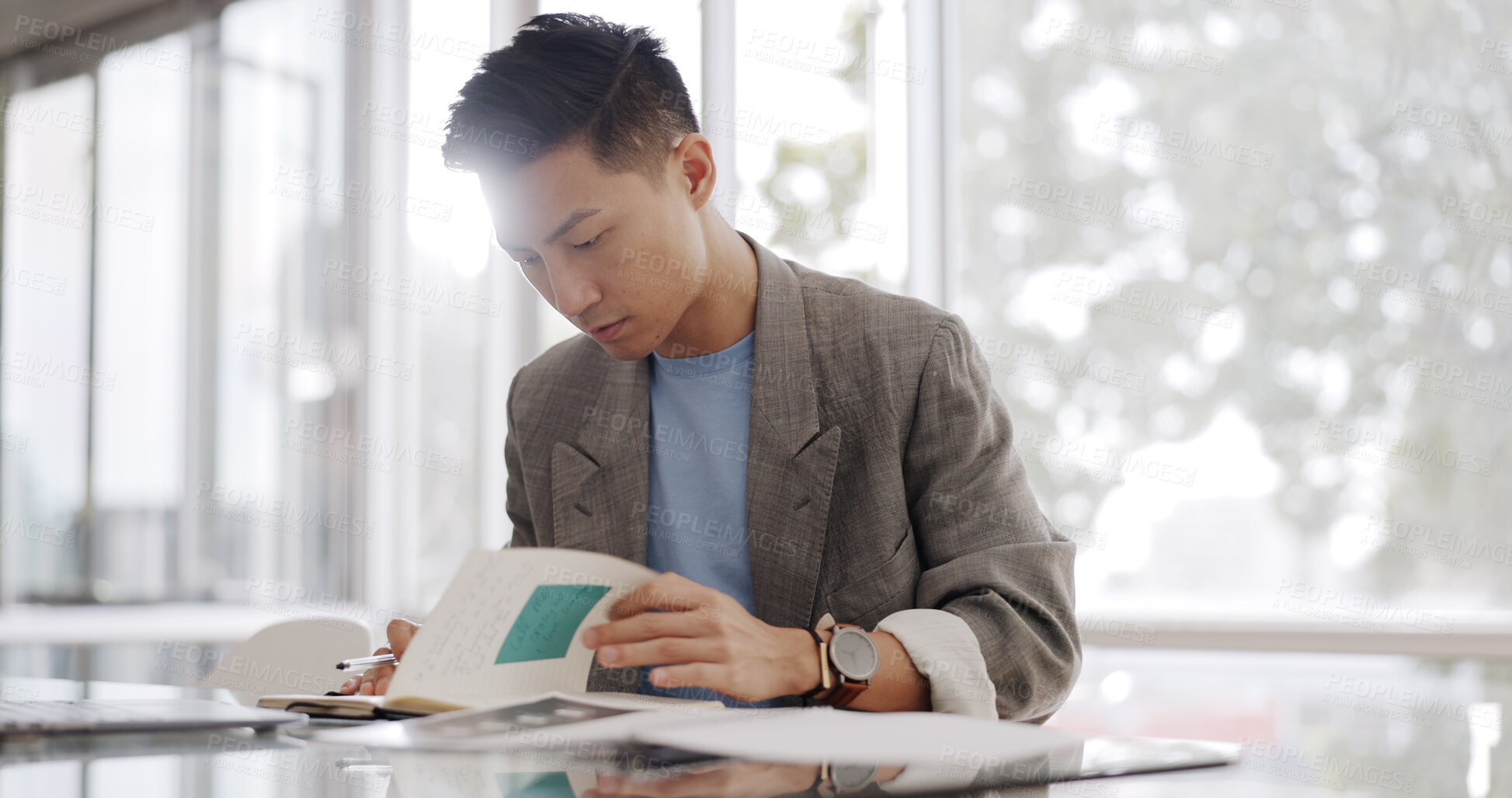 Buy stock photo Reading, notebook and planning with a business asian man in the office for research or strategy on a company project. Appointment, calendar or journal with a young employee checking his schedule