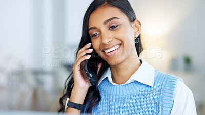 Young business woman talking on a phone call in an office. Confident designer smiling while communicating in a successful startup. Getting good news while networking and making deals with clients