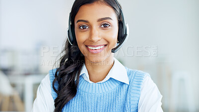 Portrait of a call center agent using a headset while consulting for customer service and sales support. Confident young businesswoman smiling while operating a helpdesk and looking confident