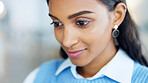 Closeup of a happy business woman’s face reading and planning a creative marketing strategy in a modern office. Young entrepreneur inspired while brainstorming and planning ideas for a startup agency