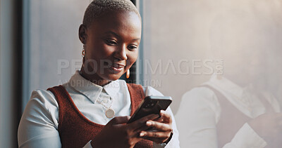 Black woman, business and typing on phone at window in office building for social networking connection, mobile app and reading notification. Happy worker, smartphone and search media on digital tech