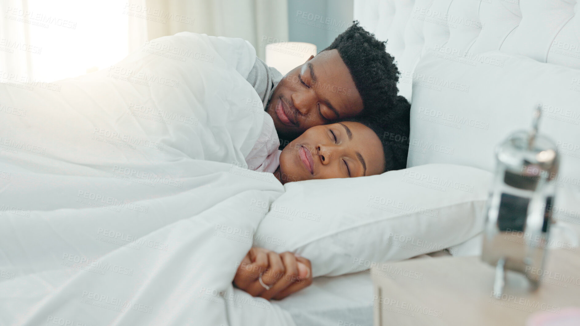 Buy stock photo Home bedroom, tired black couple and sleep together for morning wellness, care and relax for love support, rest or dream. Fatigue, apartment bed or African woman, cozy man or marriage people sleeping