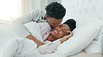 Relax, couple and love in bedroom kiss, rest and comfort in happy relationship together at home. Man and woman lying in bed relaxing, talk and smile in comfortable house and morning happiness