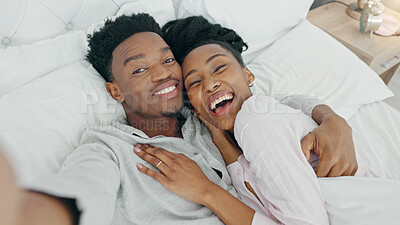 Selfie and happy influencer couple vlogging their honeymoon while lying in bed to love and relax together at home. Portrait of a loving black man and woman having romantic moment in the morning