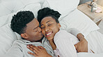 Selfie, kiss and happy influencer couple vlogging their honeymoon while lying in bed to love and relax together at home. Portrait of a loving black man and woman having romantic moment in the morning