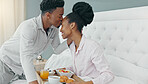 Breakfast in bed, love and black couple being romantic on their honeymoon, birthday or anniversary in a hotel room. Happy man kissing woman on head to express love and care while bonding in bedroom