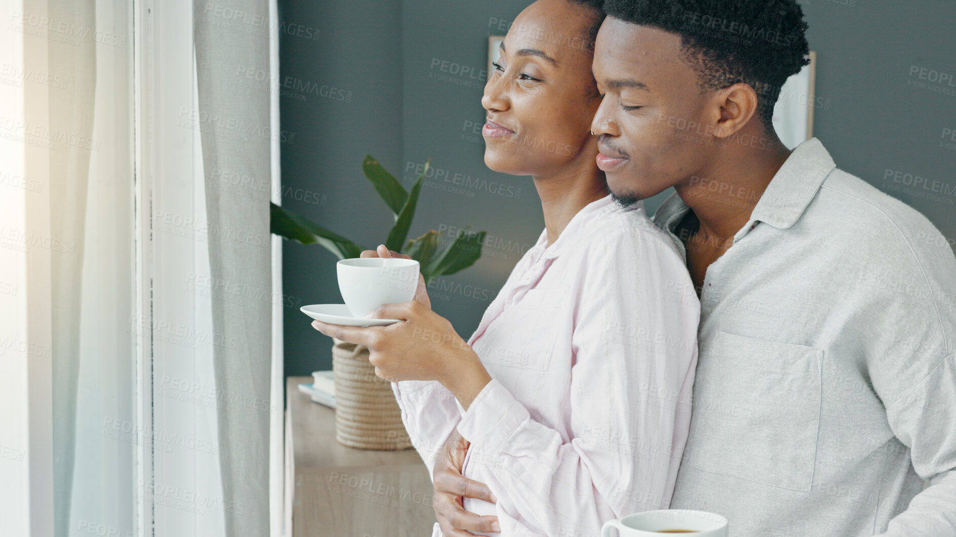 Buy stock photo Couple, hug and coffee in the morning for love, happiness and care while looking out the window in bedroom of home. 
Romance, black woman and man in room embrace for commitment and healthy marriage 
