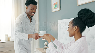 African couple drink coffee in bed, relax with tea in bedroom and happy in the morning in house. Man and woman with drinks for breakfast in home, energy after sleeping and conversation in apartment