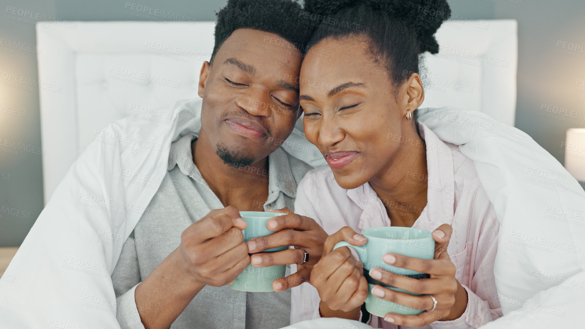 Buy stock photo Coffee, bed and couple relax in morning in their home bedroom together. Drink, tea and love of black man and woman with care, comfort and support in healthy and happy marriage on vacation at a house