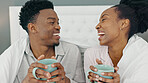 Coffee, smile and a couple drinking in bed together on a lazy day at home. Love, a winter warm up and a hot beverage on a cold morning, black woman and happy man with duvet and a fresh cup in bedroom