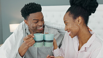 Smile, love and happy black couple drink a cup of coffee on a bed in the morning at home. People in loving, smiling in the bedroom with a warm beverage. Romantic young man and woman bonding in house