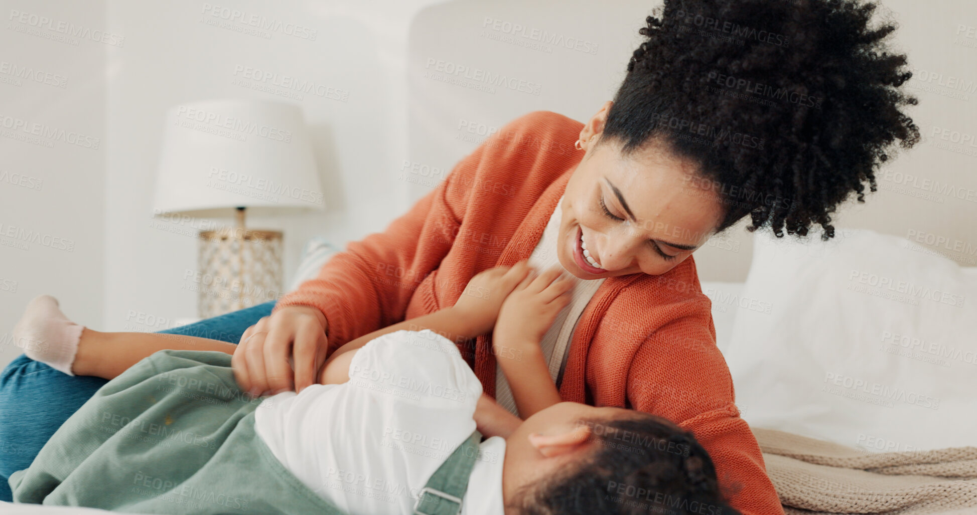 Buy stock photo Mother, child and love in home bedroom lying in bed together for fun, tickling and laugh on family vacation. Happy African woman or parent playing with girl kid for wellness, game and holiday memory