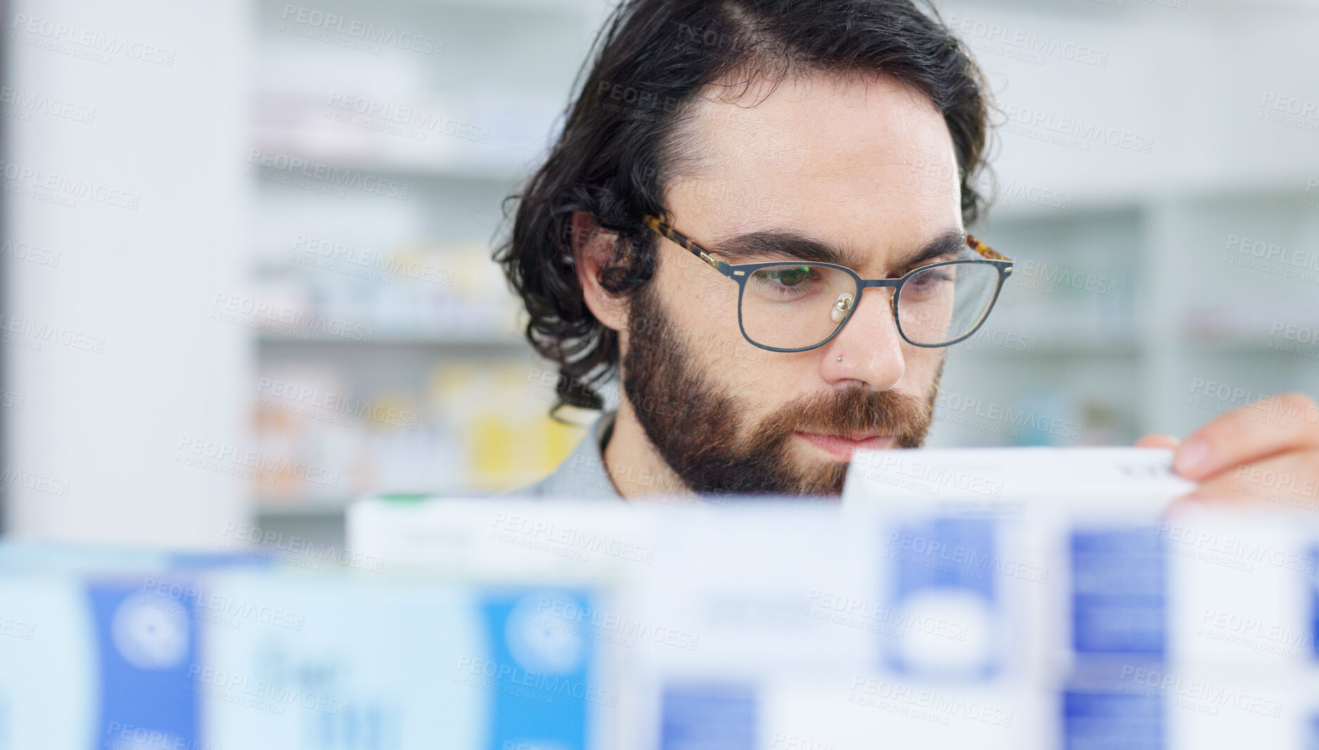 Buy stock photo Pharmacy, man and customer with medication option, glasses and shelf with vitamins. Person, client and guy with eyewear, drugstore and pills with healthcare, medical products and choice for items