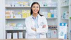 Portrait of a cheerful and friendly pharmacist using a digital tablet to check inventory or online orders in a chemist. Young latino woman using pharma app to do research on medication in a pharmacy