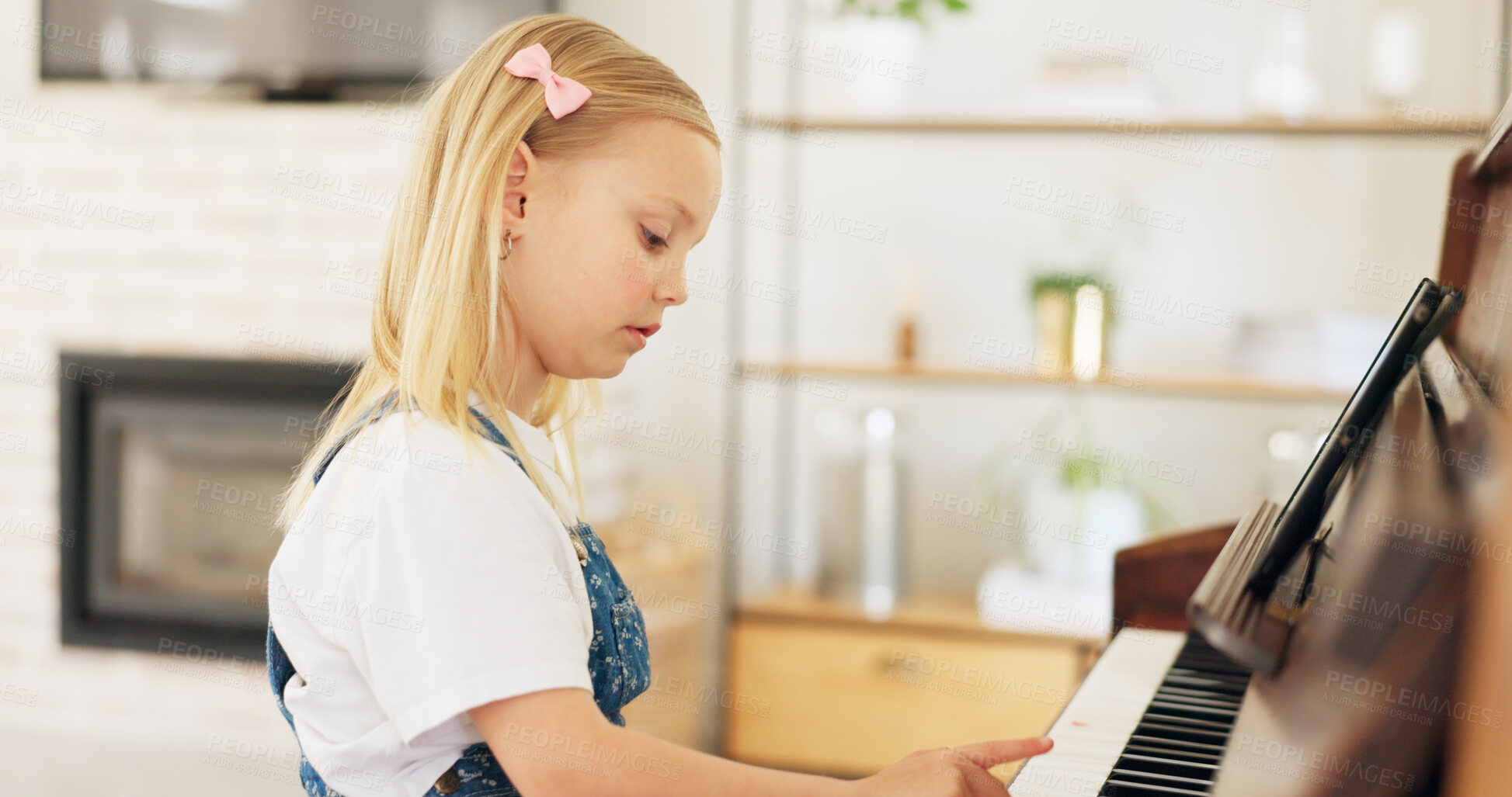 Buy stock photo Child, piano music and playing instrument at home for development, keys and learning. Little girl kid or serious student practice notes for pianist lesson, training and musician talent at a house