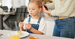 Hair care, brush and kid with mother talking, play and relax in home kitchen during morning breakfast. Mom prepare for day, bonding time and child care for happy family youth girl with mama's love