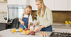 Breakfast, morning and mother and kid cooking, help or prepare croissant meal, fruit or food in home kitchen. Love, happy family and youth girl with mom, mama or woman enjoy fun quality time and bond