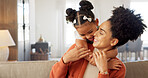 Happy, mother and child with hug, kiss and love for playful relationship bonding on living room sofa at home. Mama and kid playing together in happiness for loving care or joy relaxing on the couch