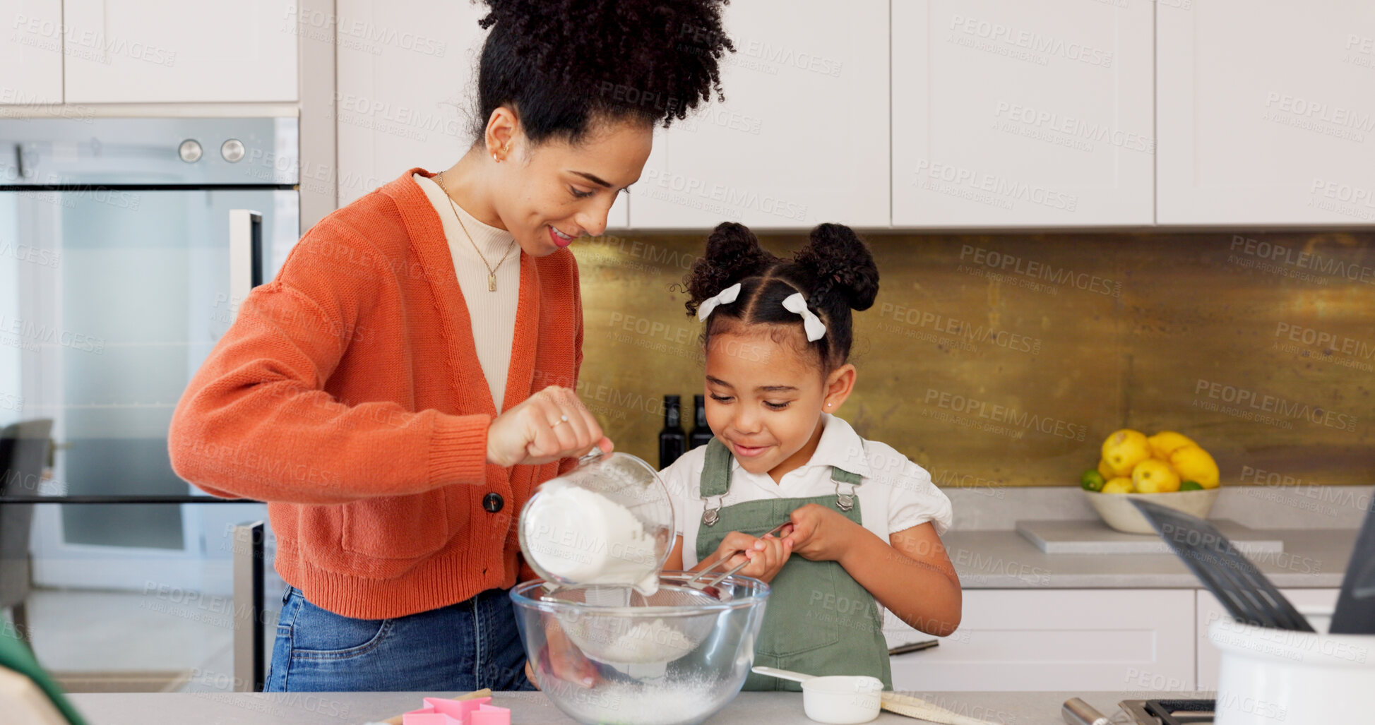 Buy stock photo Baking, kitchen and mother with girl learning, helping and bonding for recipe, food and dessert. Happy family, African parents and mom teaching child to bake with flour, ingredients and cake in home