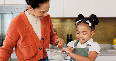Mother, child and learning for baking with flour helping in the kitchen with recipe or ingredients at home. Happy mom teaching helpful kid to bake or mix together with smile for family bonding time