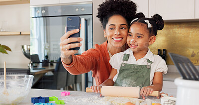 Mother, girl and phone selfie while cooking in kitchen, bonding and having fun. Learning, baking and mom, kid and 5g mobile for social media, picture or online post with victory hands or peace sign