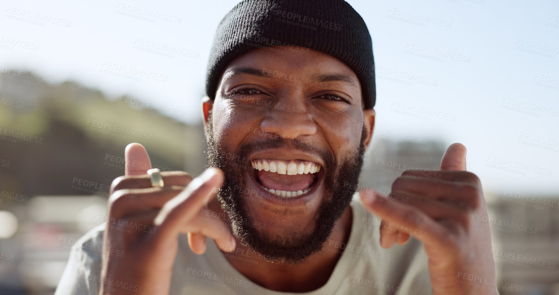 Buy stock photo Portrait, energy and hand gesture with a black man in the city for freedom outdoor during summer. Face, smile and excited with a happy young person on a roof in an urban town to sign an expression