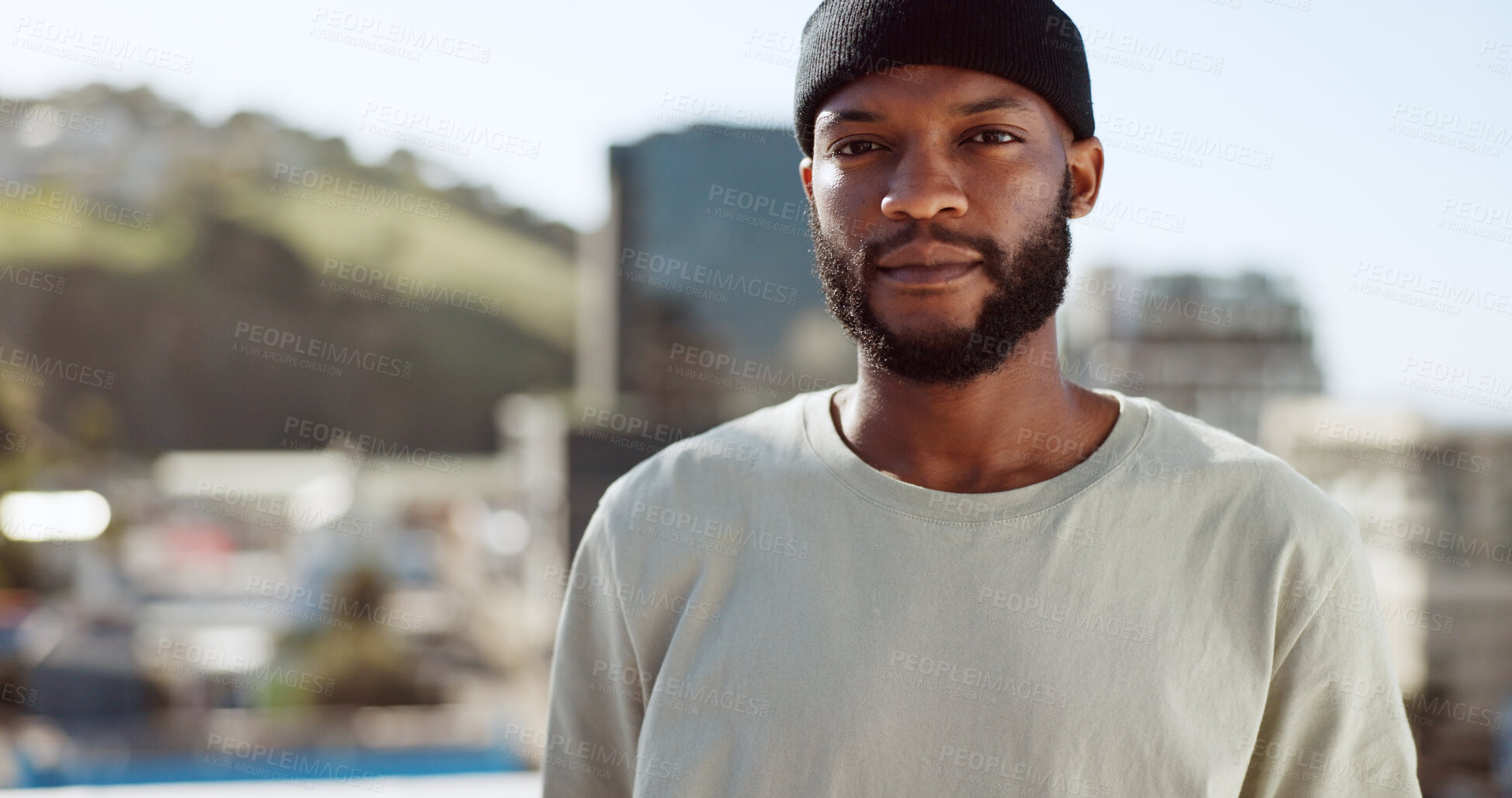 Buy stock photo Portrait, serious and a black man in the city on a roof during summer for fashion or style. Face, confident and a cityscape of buildings with a young person outdoor for freedom in an urban town