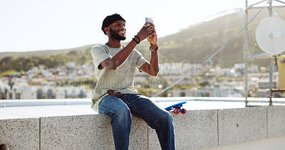 Smartphone, selfie and black man on rooftop for cityscape photography with skateboard relax outdoor. Happy man using phone or cellphone for social networking skate update of location