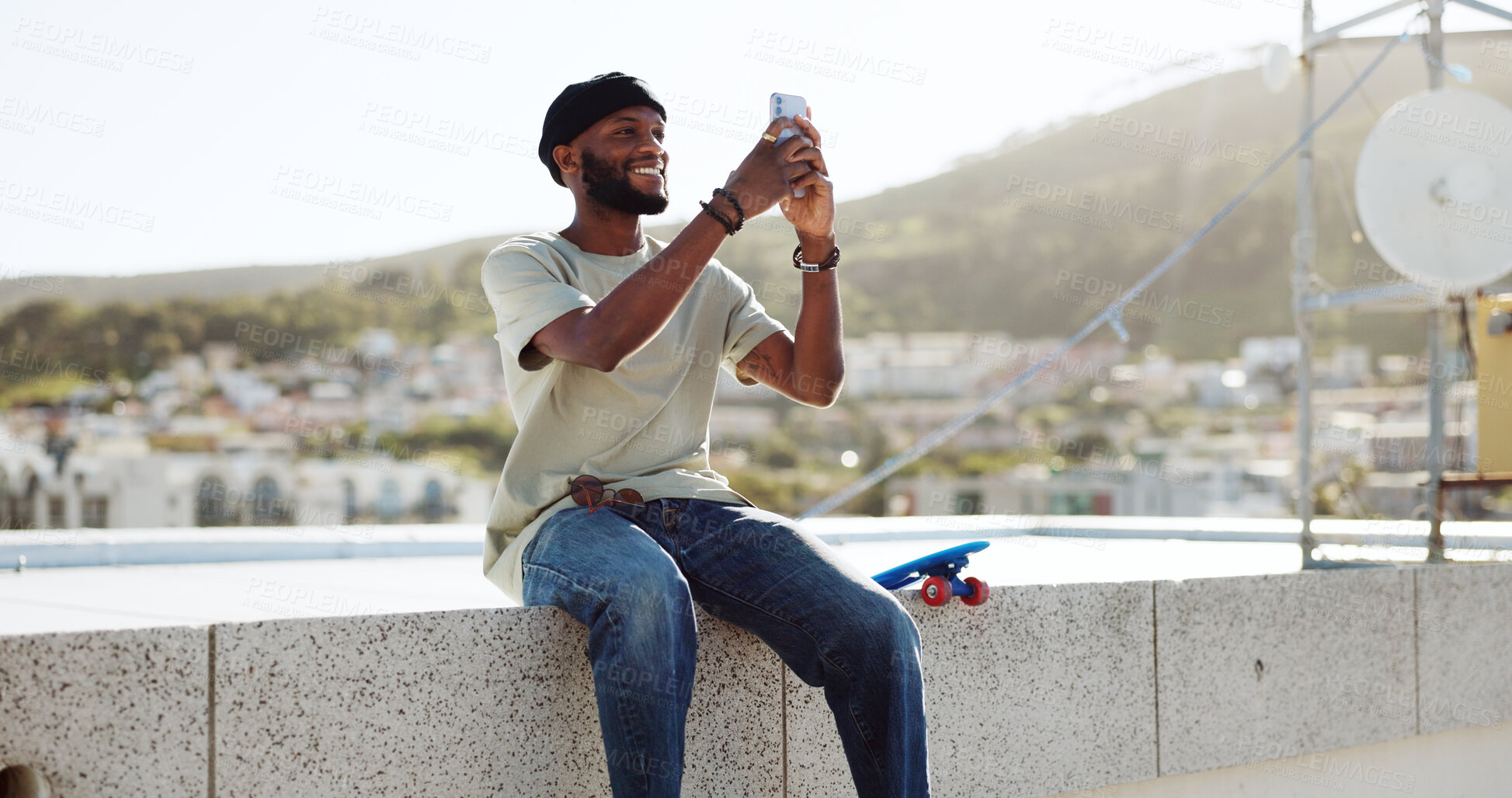 Buy stock photo Black man, selfie on rooftop and social media post, memory while at skate park with app and happy outdoor. Influencer, content creation and smile in picture with cityscape, trendy skater and travel
