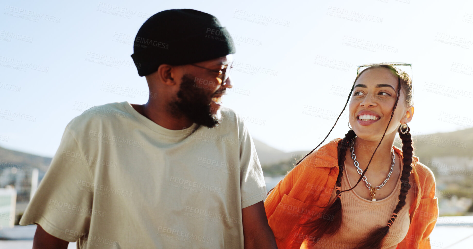 Buy stock photo Couple of friends, rooftop and happy city conversation, talking and youth in social bonding on summer sky. Diversity, gen z man and woman sit on roof with smile, love and relax on urban date together