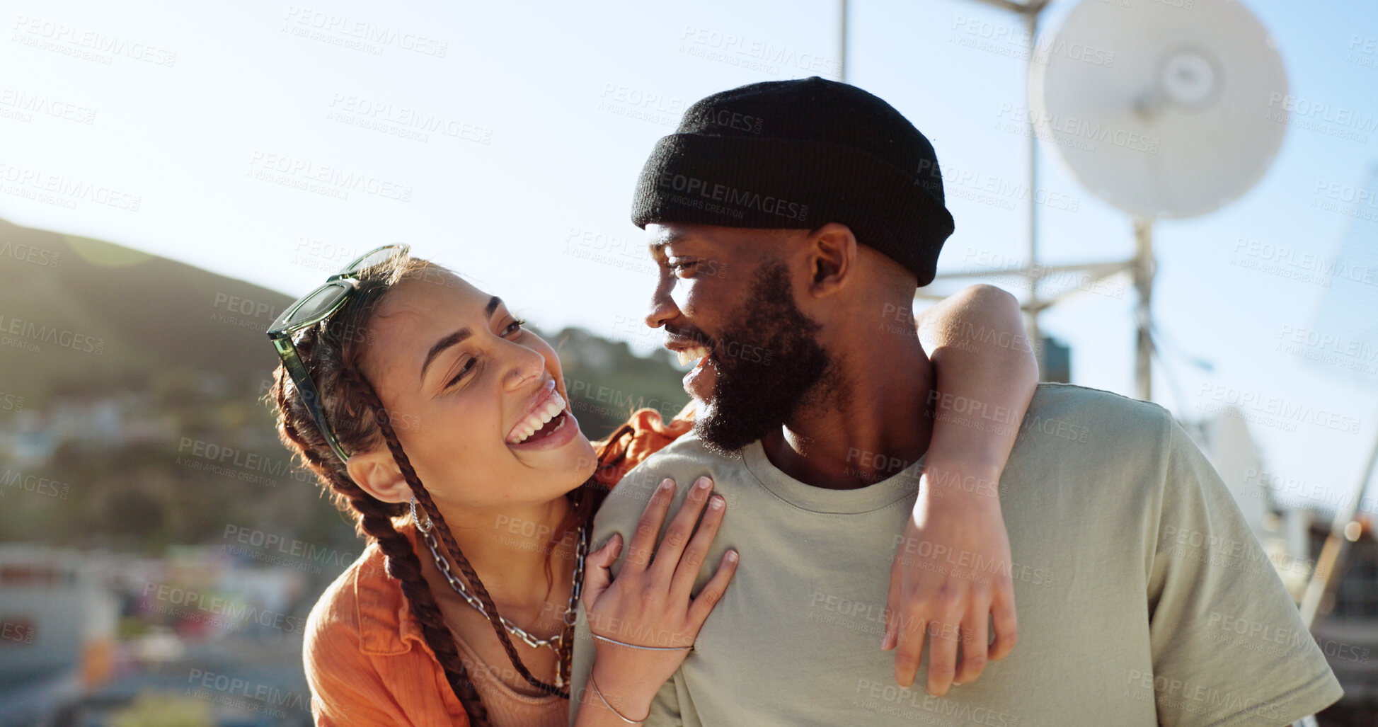 Buy stock photo Couple of friends, rooftop and hug on city building, social and youth in happy bonding with summer sky. Diversity, gen z man and woman sit on roof with smile, love and relax on urban date together.