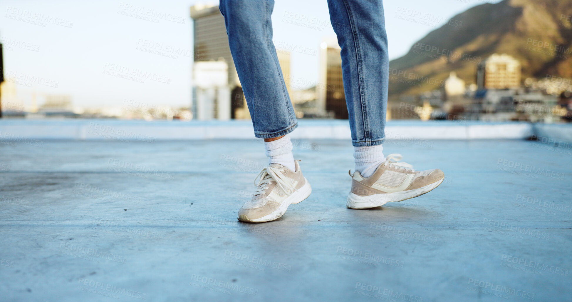 Buy stock photo Shoes, dance and music with a person on a rooftop in the city, feeling carefree and excited about freedom. Feet, action and movement with a dancer outdoor on an urban background for a performance