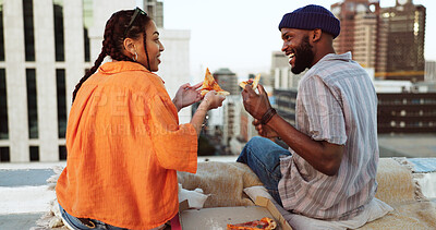 Couple, eating and pizza date on city building rooftop in New York for bonding, trust or love support. Smile, happy or talking woman and black man with fast food in relax tourist location for summer