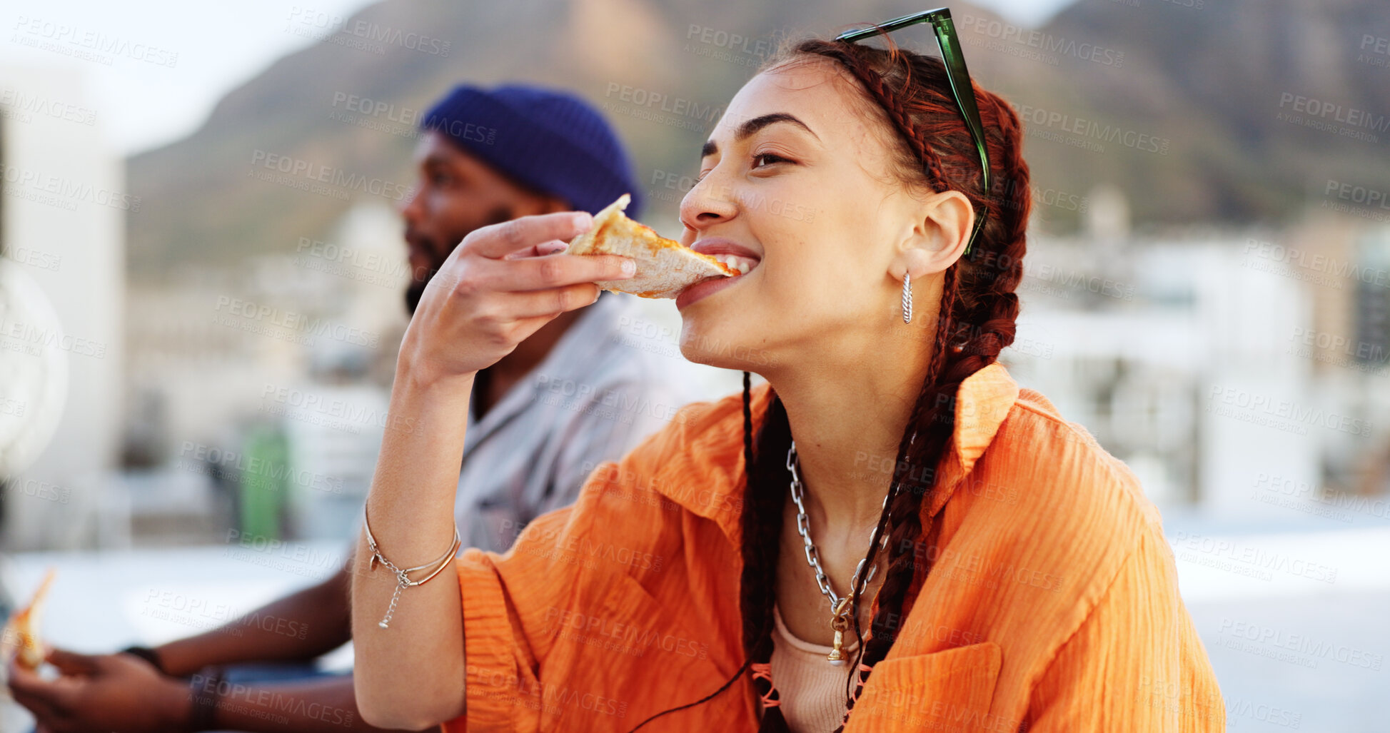 Buy stock photo Pizza, rooftop and woman eating outdoor with friends for urban, gen z and food with a smile. Happy, relax and hungry people with fast food in a city with party, freedom and hipster group on roof