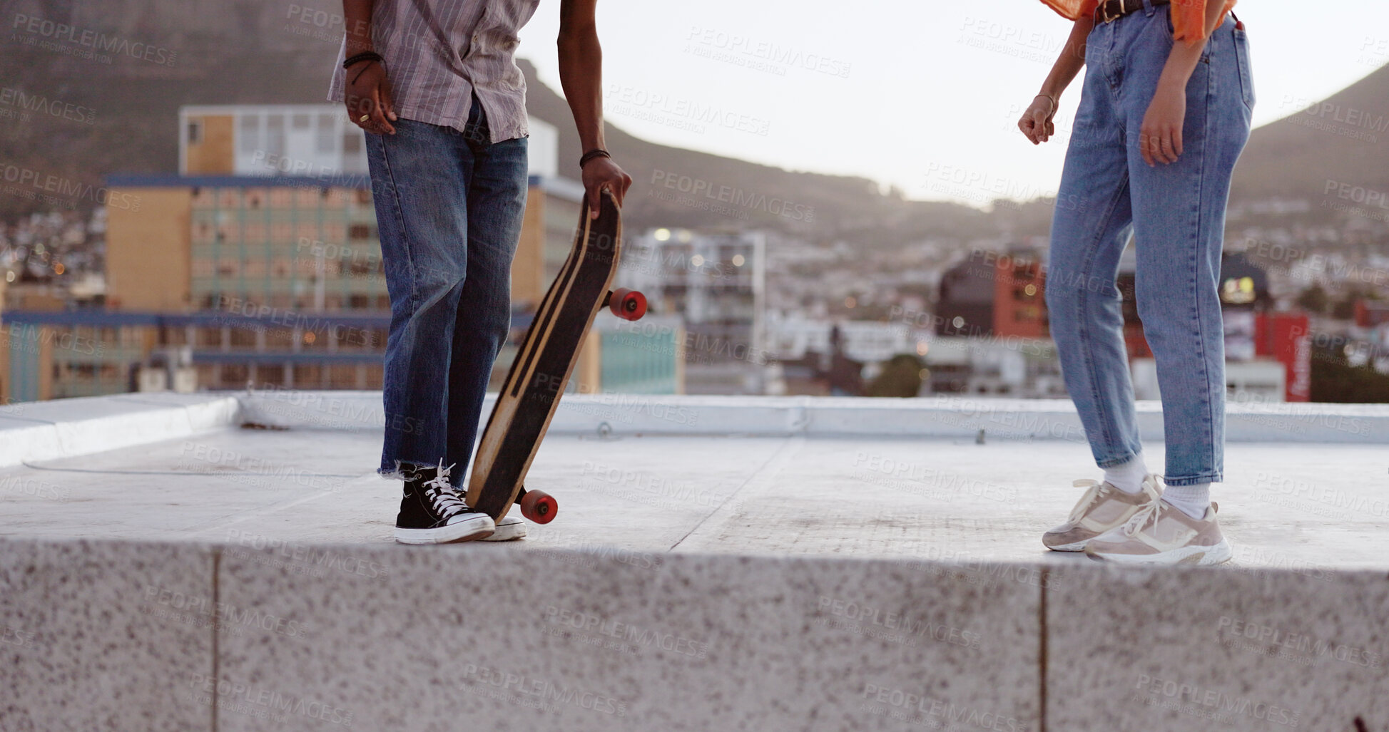 Buy stock photo Skateboard, legs and couple in city outdoor on a rooftop, training or exercise. Skating on board, man and woman closeup in urban town for sports, workout or skater practice together for healthy body