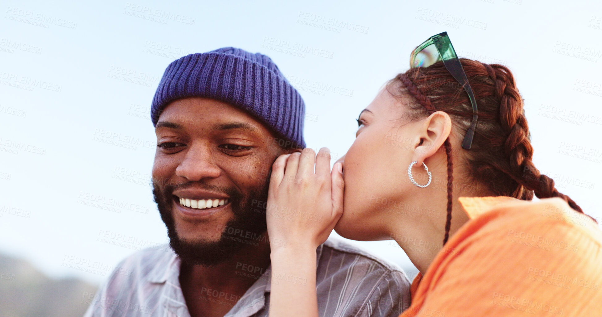 Buy stock photo Whisper, communication and couple in a gossip conversation about secret, rumor or interesting friend news. Rooftop discussion, talking in ear and gen z woman share information to listening black man