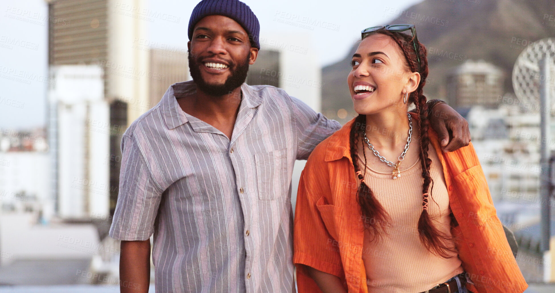 Buy stock photo Couple of friends hug on rooftop date, city building and youth in happy social bonding with freedom. Diversity, gen z man and woman on roof with smile, love and relax on outdoor urban date together.