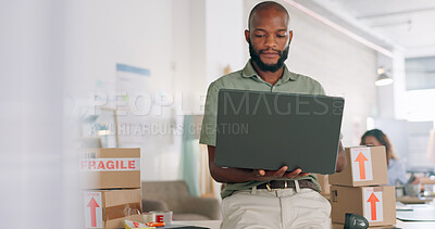 Laptop, creative and online order with a black man designer working in a workshop for shipping or delivery. Computer, ecommerce and logistics with a male managing stock or the shipment of goods